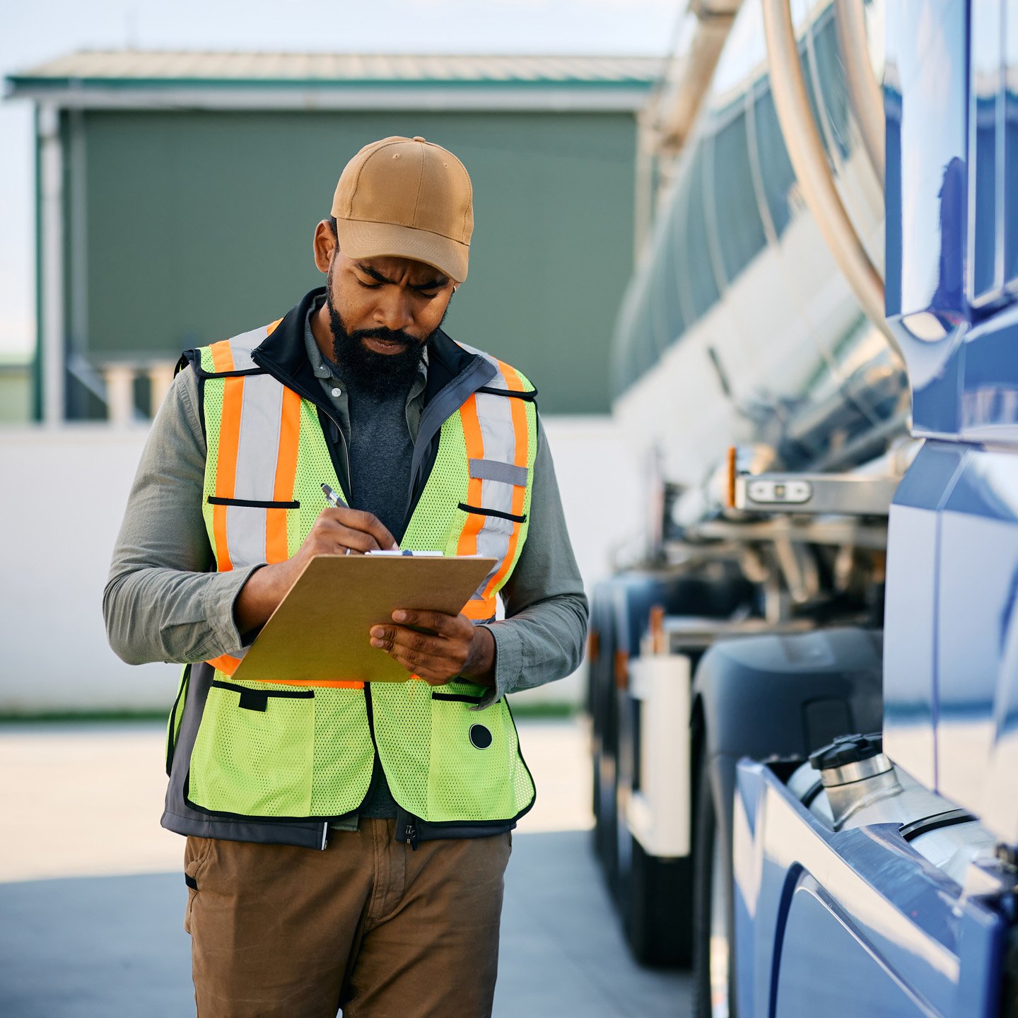 Truck driver inspecting load with clipboard